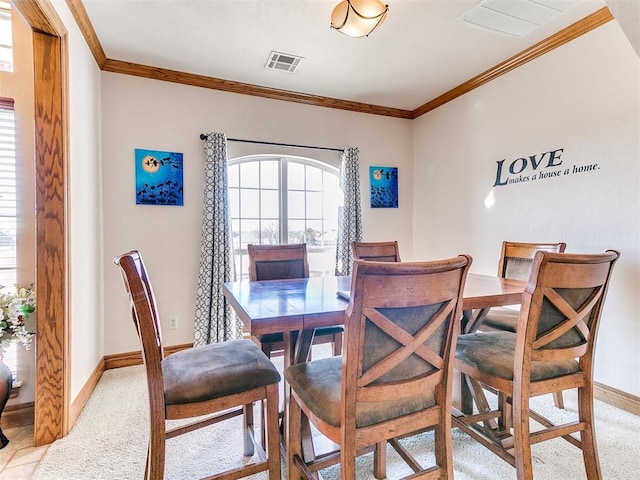 dining area featuring crown molding and light carpet