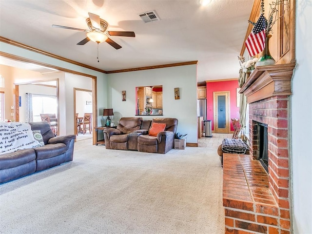 living room with crown molding, a brick fireplace, light carpet, and ceiling fan