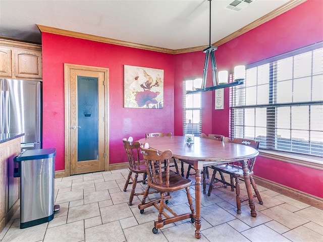 tiled dining space featuring crown molding