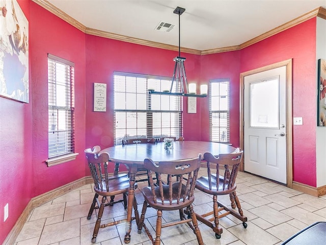 tiled dining room featuring crown molding