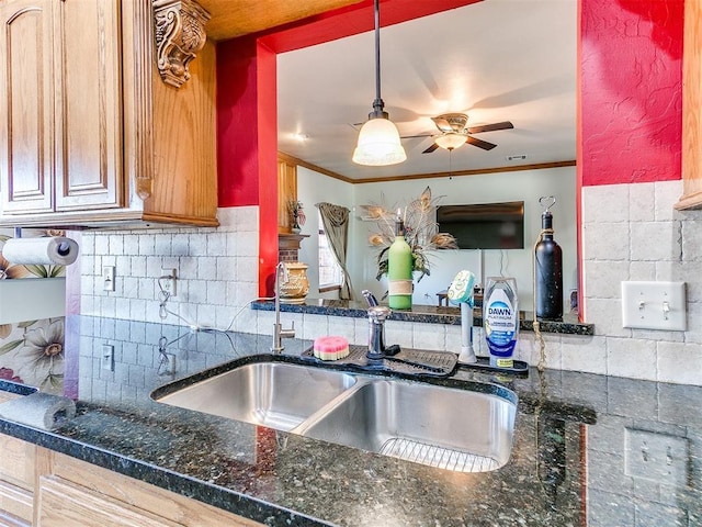 kitchen with crown molding, sink, decorative backsplash, and decorative light fixtures