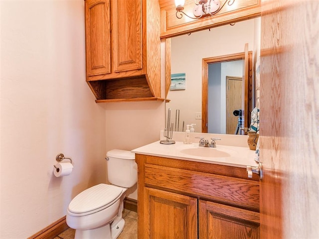 bathroom with vanity, toilet, and tile patterned flooring