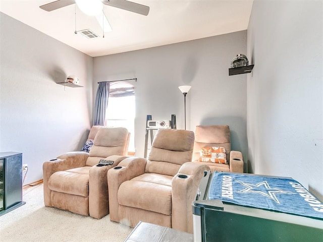 sitting room with carpet and ceiling fan