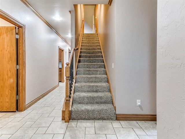 staircase featuring crown molding