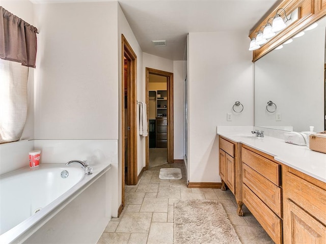 bathroom with vanity and a bath