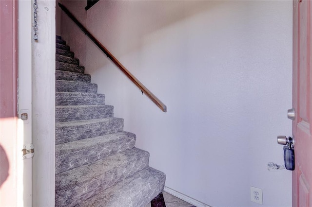 staircase featuring tile patterned flooring