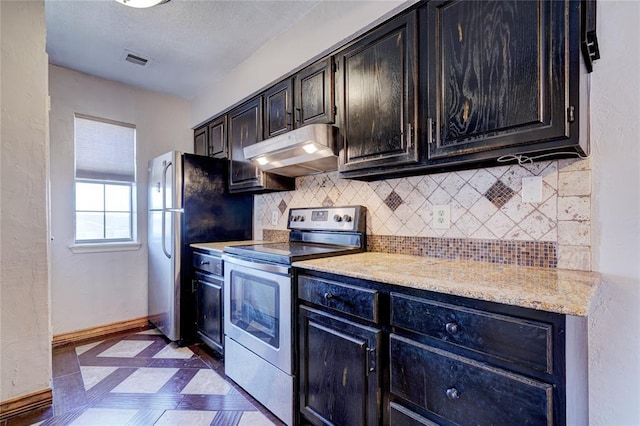 kitchen featuring stainless steel appliances, light stone countertops, and backsplash