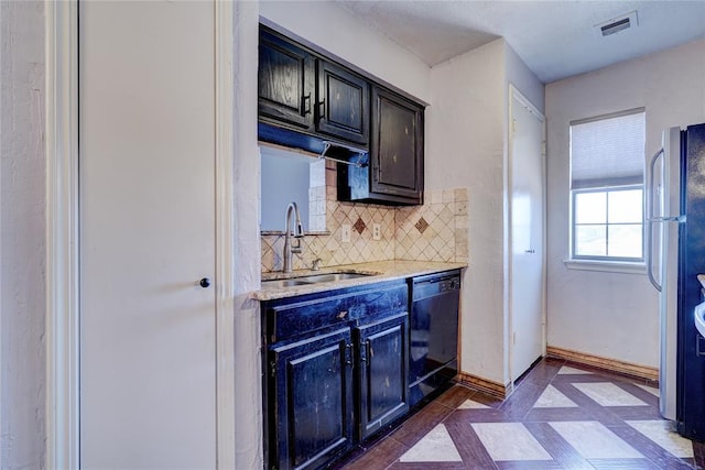 kitchen featuring backsplash, stainless steel refrigerator, sink, and dishwasher