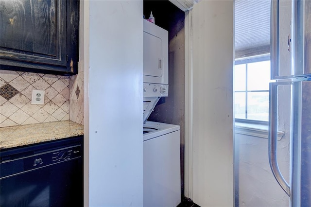 laundry room with stacked washer / drying machine