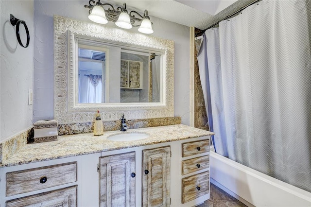 bathroom featuring vanity and shower / bathtub combination with curtain