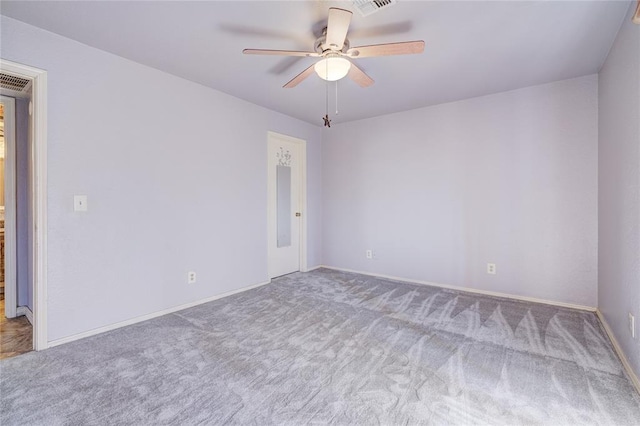 empty room with ceiling fan and light carpet