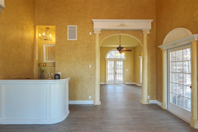 interior space with ceiling fan, a healthy amount of sunlight, dark hardwood / wood-style flooring, and french doors