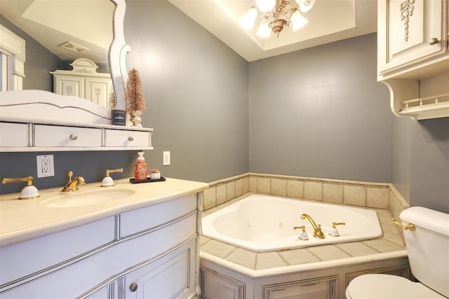 bathroom featuring a washtub, vanity, vaulted ceiling, and toilet