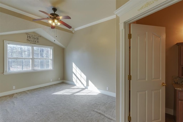 carpeted empty room featuring crown molding, ceiling fan, and lofted ceiling