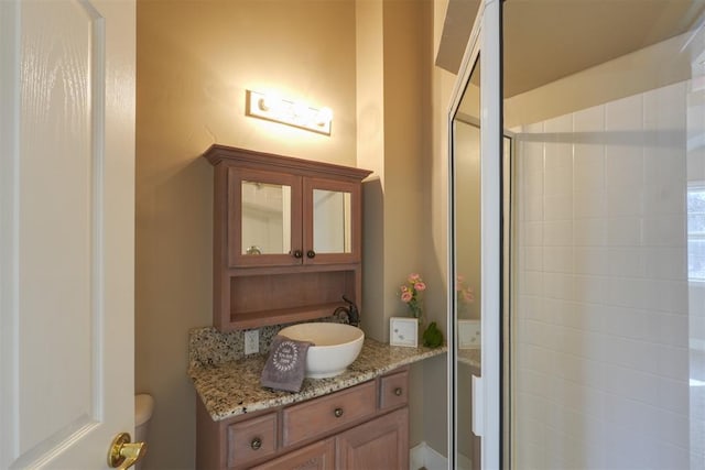 bathroom with vanity and a shower with shower door