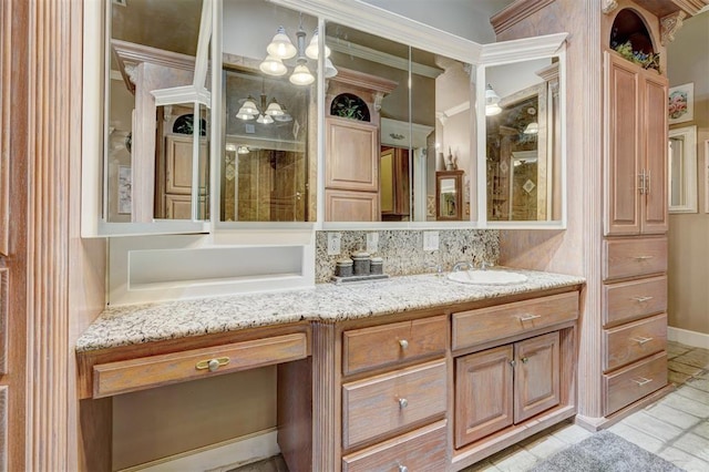 bathroom featuring tile patterned floors, decorative backsplash, ornamental molding, and vanity