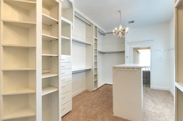 walk in closet featuring an inviting chandelier and light carpet