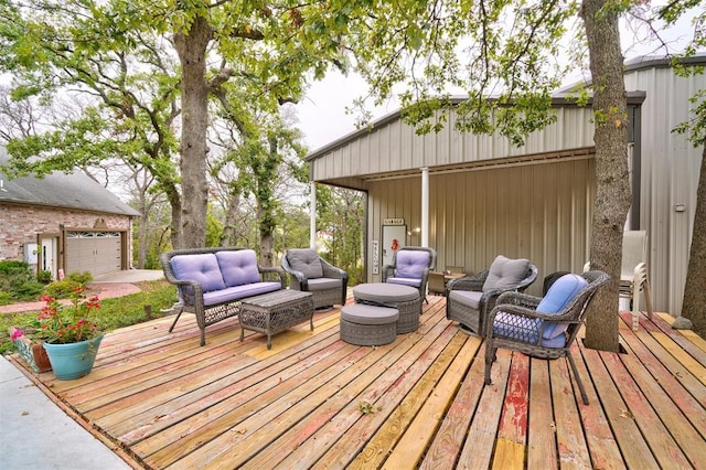 deck with a garage and an outdoor hangout area