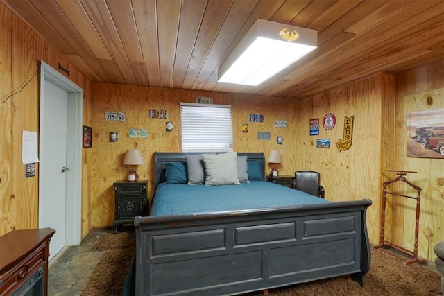 bedroom with dark colored carpet, wood ceiling, and wooden walls