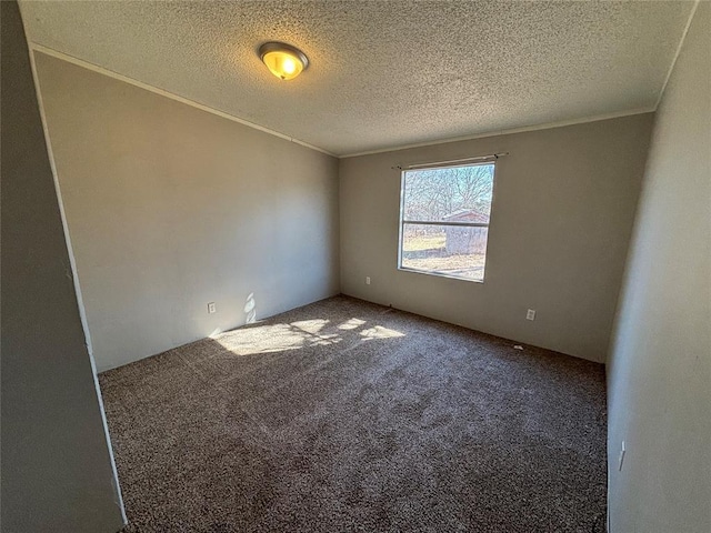 carpeted empty room featuring a textured ceiling