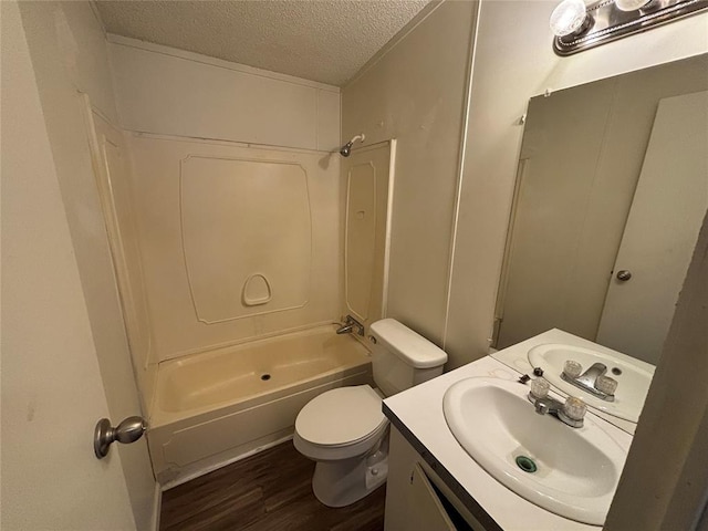 full bathroom featuring toilet, shower / bathing tub combination, a textured ceiling, vanity, and hardwood / wood-style floors