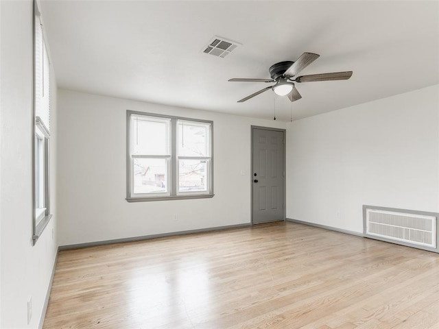 empty room featuring ceiling fan and light wood-type flooring