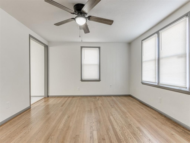 unfurnished room with plenty of natural light, light hardwood / wood-style floors, and ceiling fan