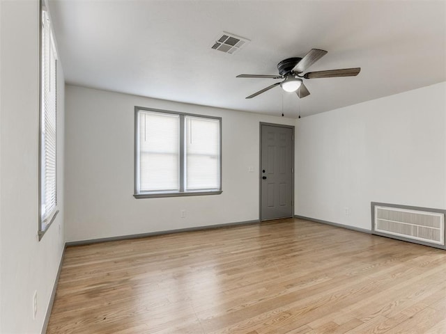 empty room with light hardwood / wood-style flooring and ceiling fan