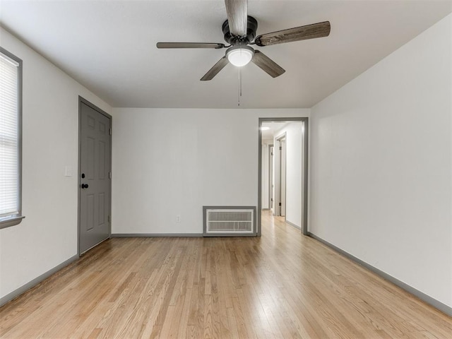 empty room featuring ceiling fan and light wood-type flooring