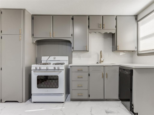 kitchen with sink, white gas stove, gray cabinetry, dishwasher, and decorative backsplash