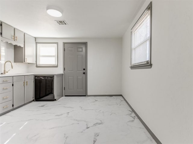 kitchen with sink, gray cabinets, and black dishwasher