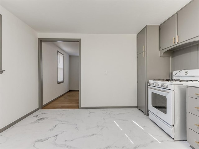 kitchen with gray cabinets and gas range gas stove