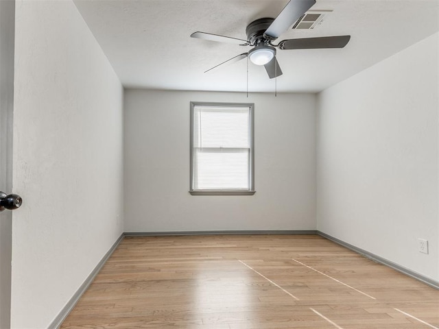 empty room featuring ceiling fan and wood-type flooring