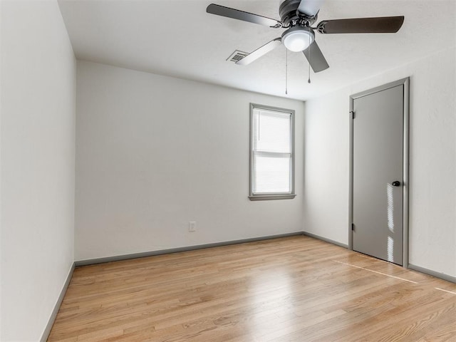 spare room featuring ceiling fan and light hardwood / wood-style flooring