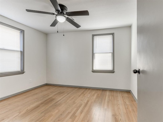 empty room with ceiling fan and light wood-type flooring