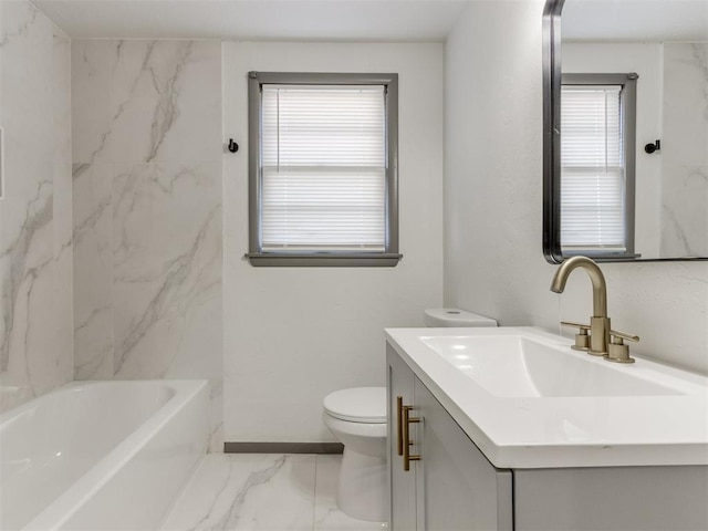 bathroom featuring vanity, a bathtub, and toilet