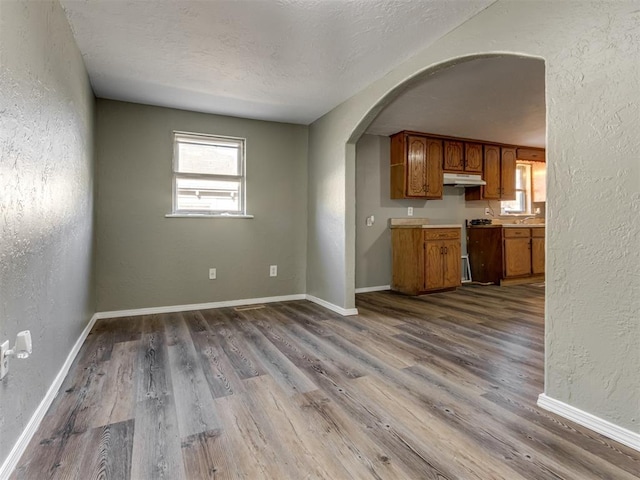 kitchen featuring hardwood / wood-style floors and a textured ceiling