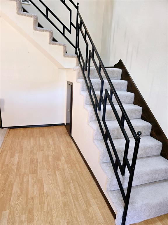 stairway with wood-type flooring