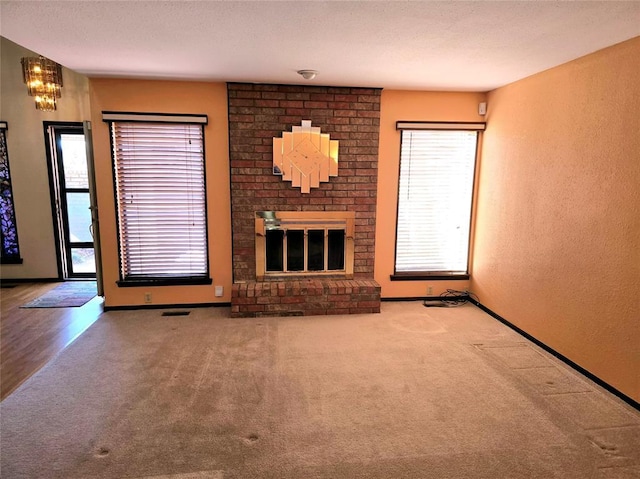 unfurnished living room with a fireplace and carpet floors