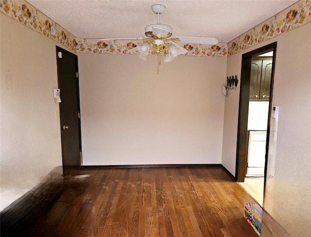 spare room featuring hardwood / wood-style flooring, ceiling fan, and a textured ceiling