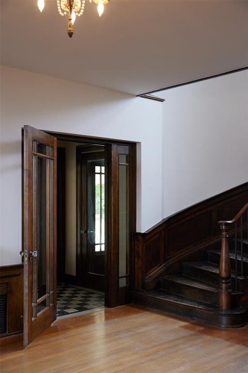 foyer entrance featuring a notable chandelier and light hardwood / wood-style flooring