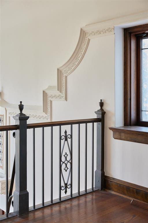 stairway featuring hardwood / wood-style floors and a wealth of natural light