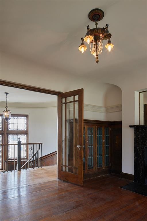 empty room featuring dark hardwood / wood-style floors and a chandelier