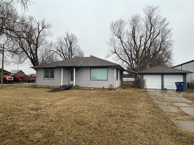 single story home with a garage, an outdoor structure, and a front lawn