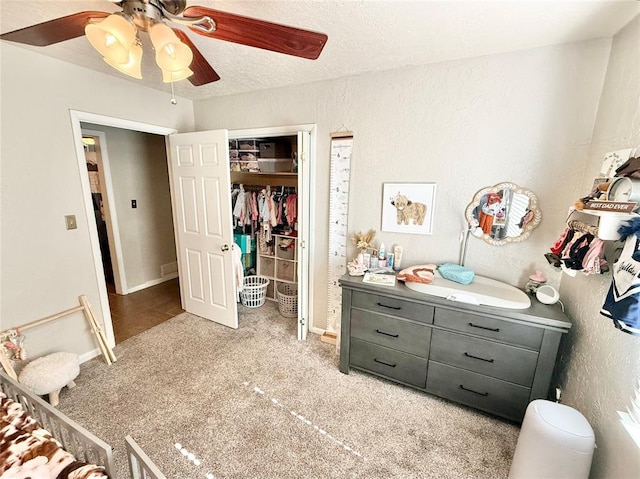 carpeted bedroom featuring a closet and ceiling fan