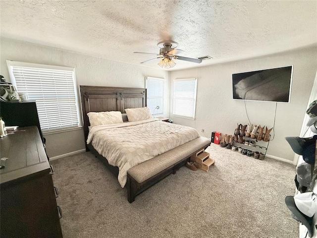 carpeted bedroom with a textured ceiling and ceiling fan