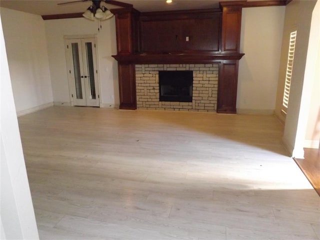 unfurnished living room featuring ceiling fan and light wood-type flooring