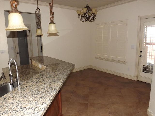 kitchen featuring light stone counters, sink, pendant lighting, and crown molding