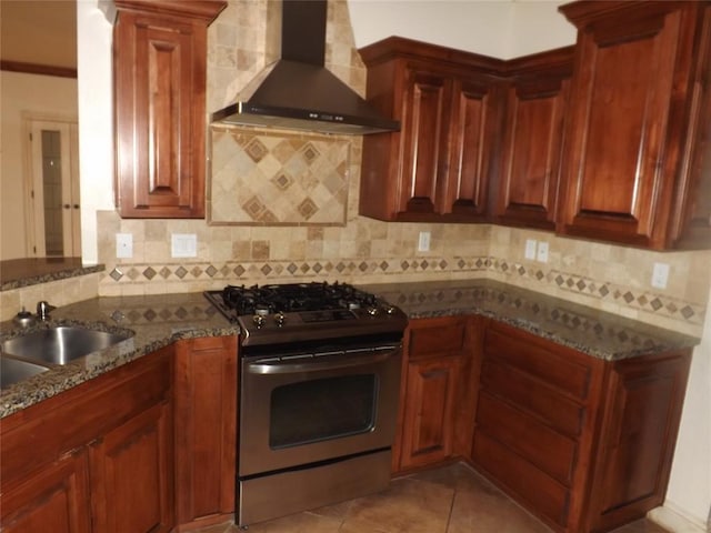 kitchen featuring sink, tasteful backsplash, stone countertops, gas range, and wall chimney exhaust hood