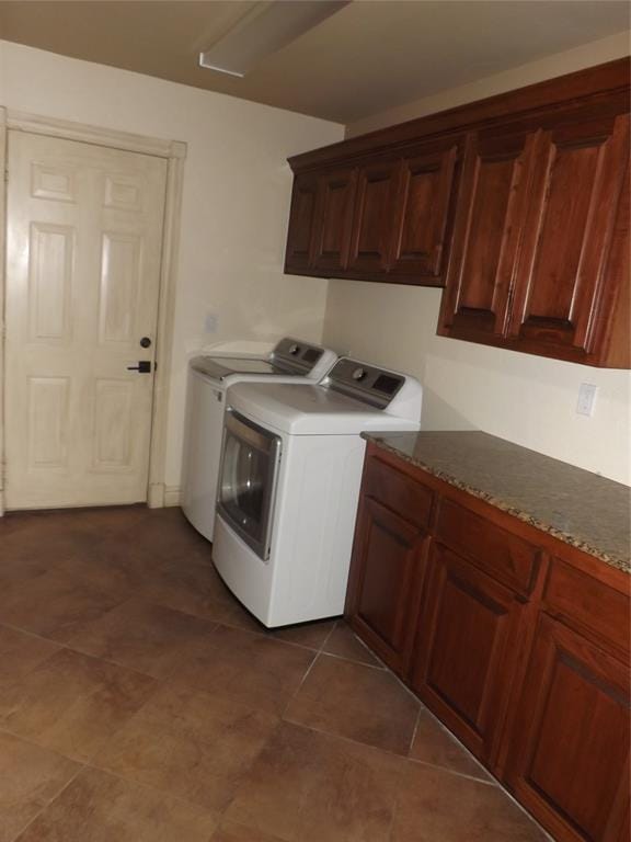 laundry room featuring cabinets and washer and clothes dryer